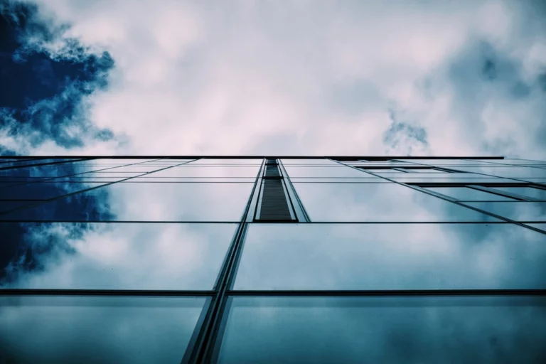 Tour de verre vue en contre-plongée sous un ciel nuageux